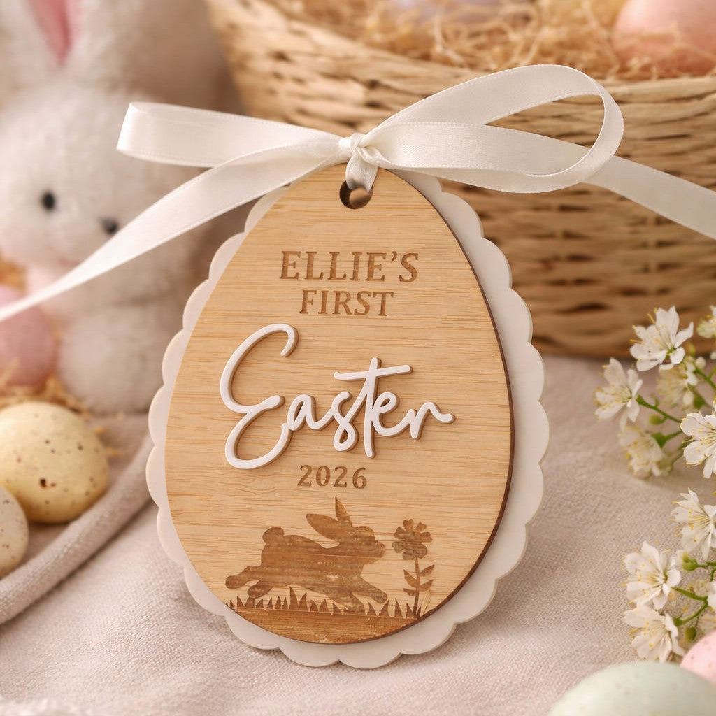 Personalised first Easter milestone ornament. Bamboo egg design with white scalloped edge and ribbon, styled with bunny and Easter decor