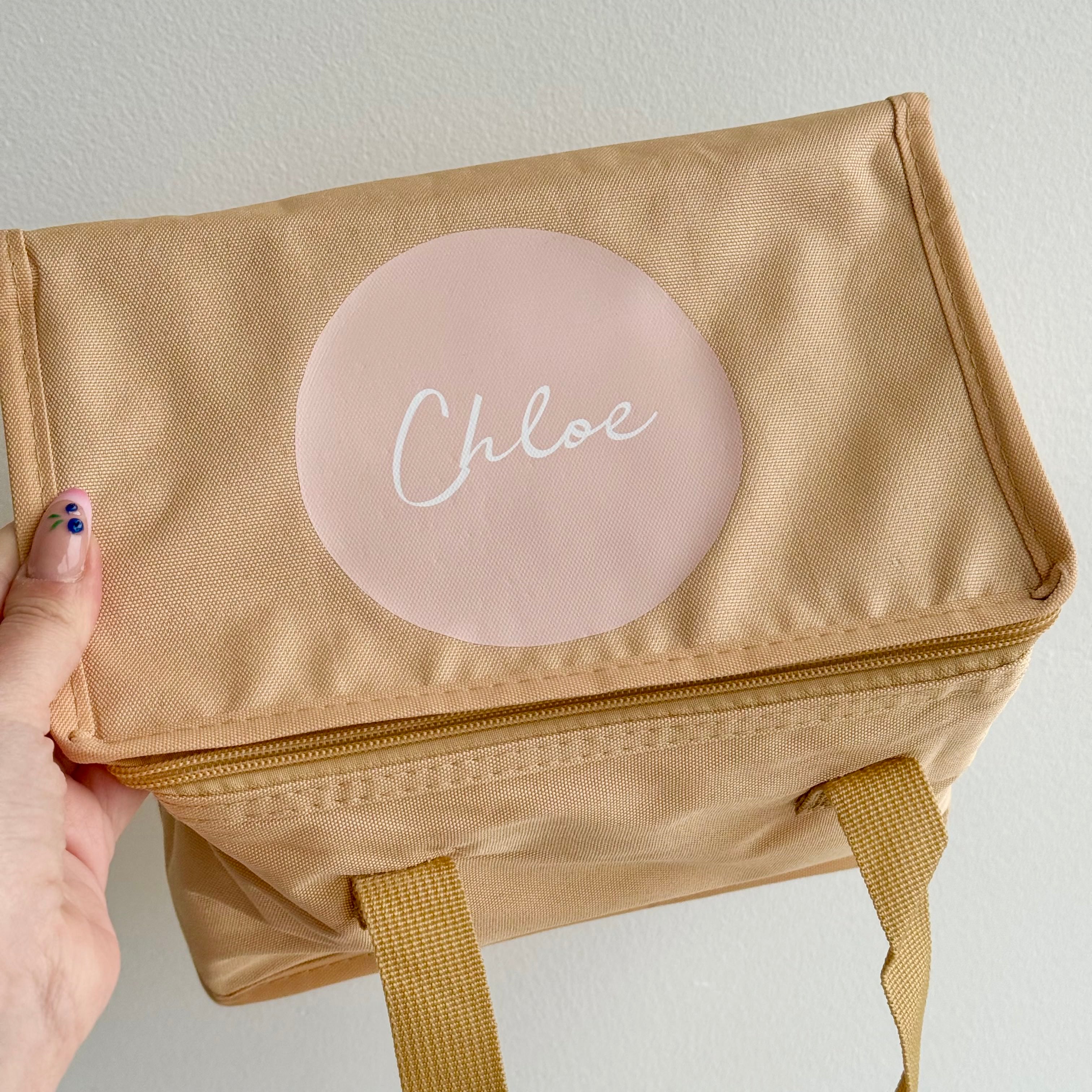 Clearance personalised beige insulated kids lunch bag with custom name printed on the lid and carry handles.