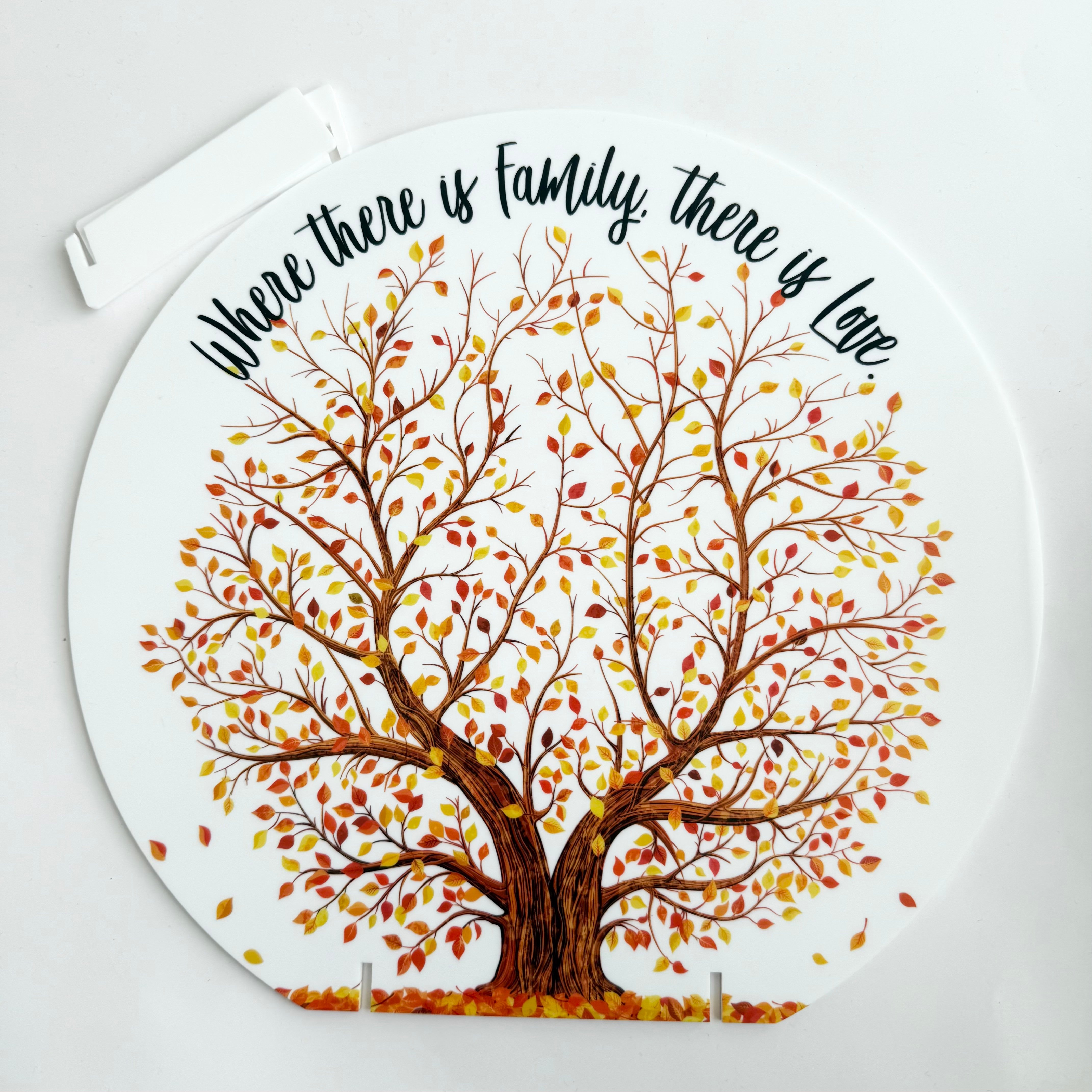 Round acrylic family tree plaque with autumn leaves and the quote “Where there is family, there is love” designed as home decor keepsake