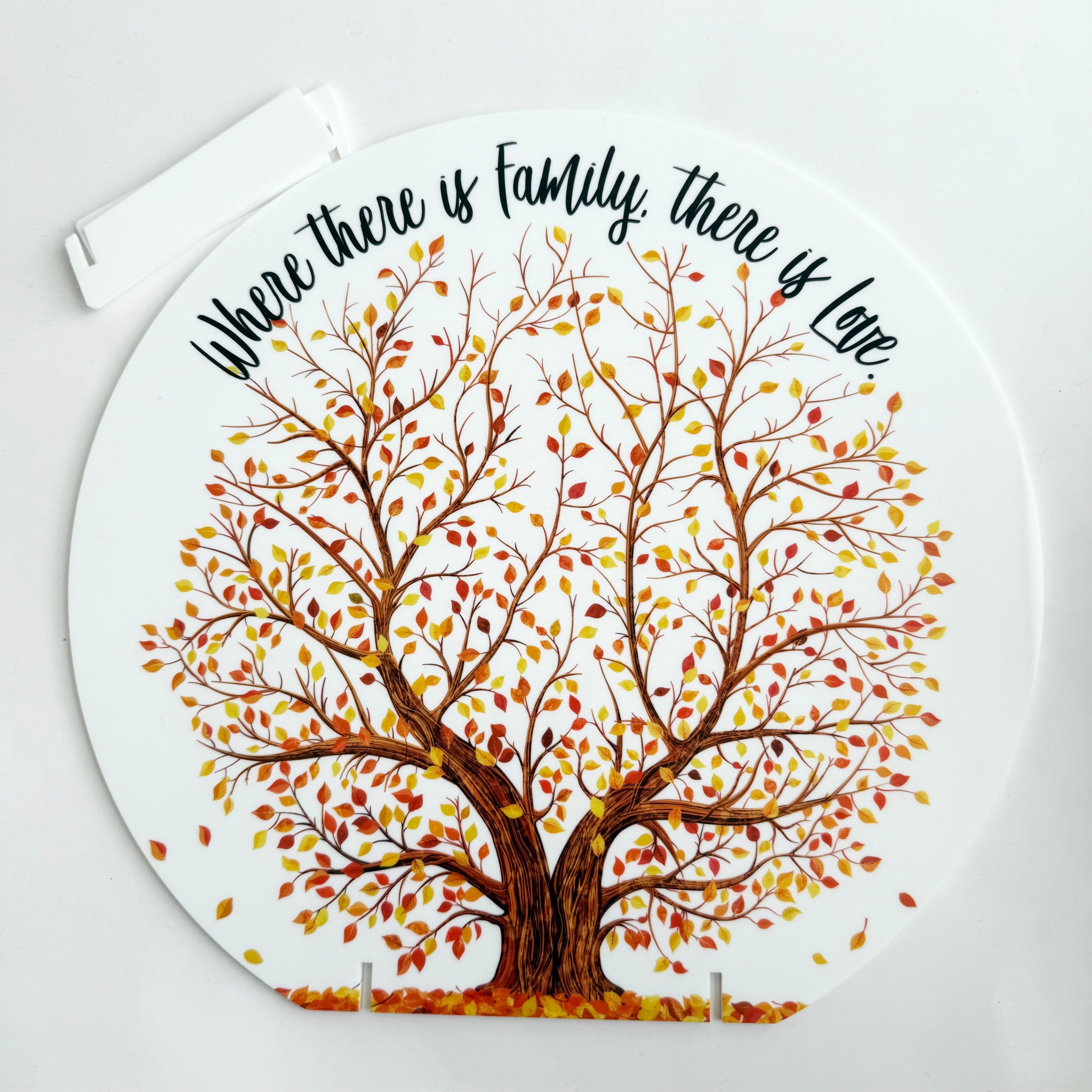 Round acrylic family tree plaque with autumn leaves and the quote “Where there is family, there is love” designed as home decor keepsake