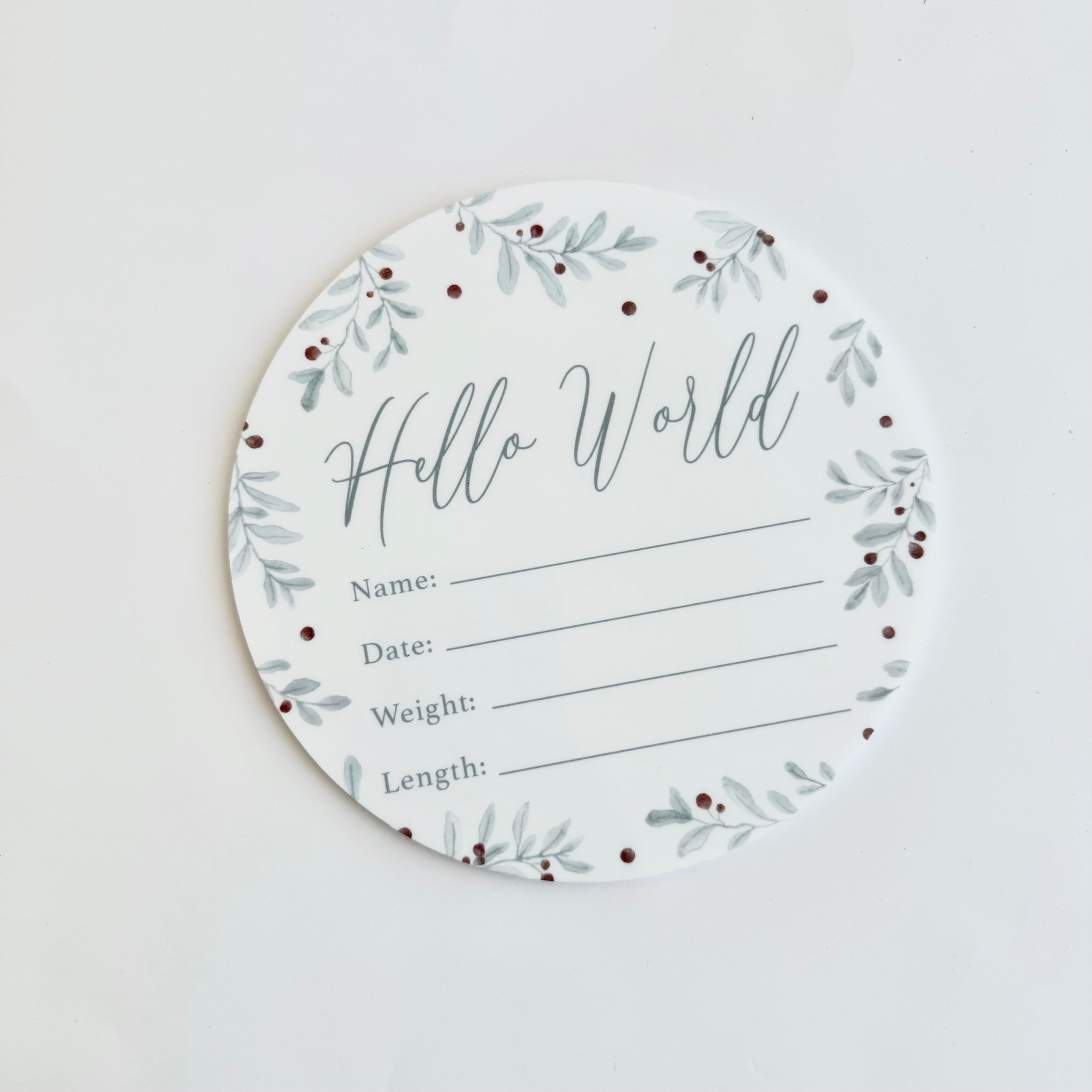 round hello world baby birth announcement card with sage green leaf design for recording newborn details