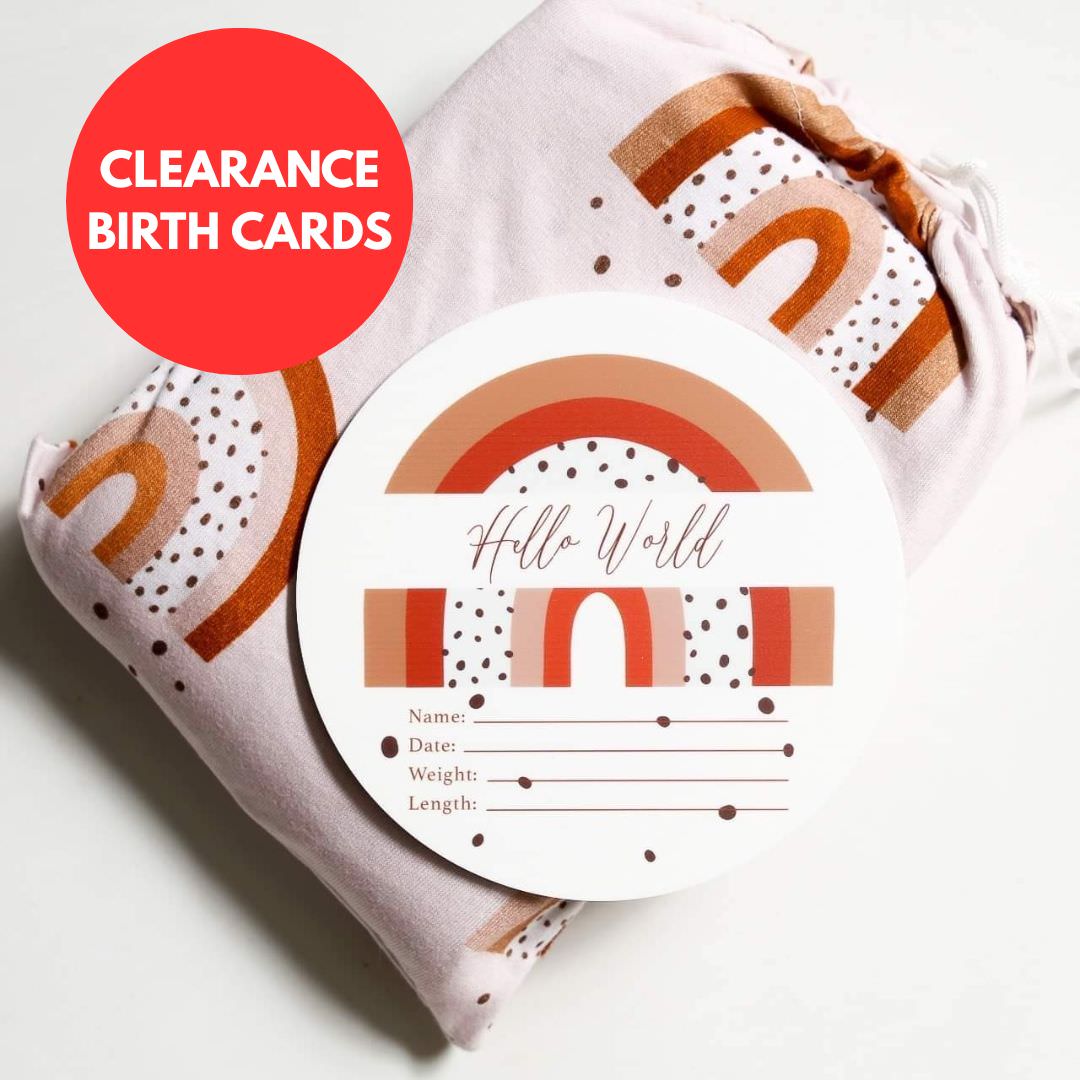 baby birth announcement card with rainbow design and hello world text placed on baby swaddle blanket