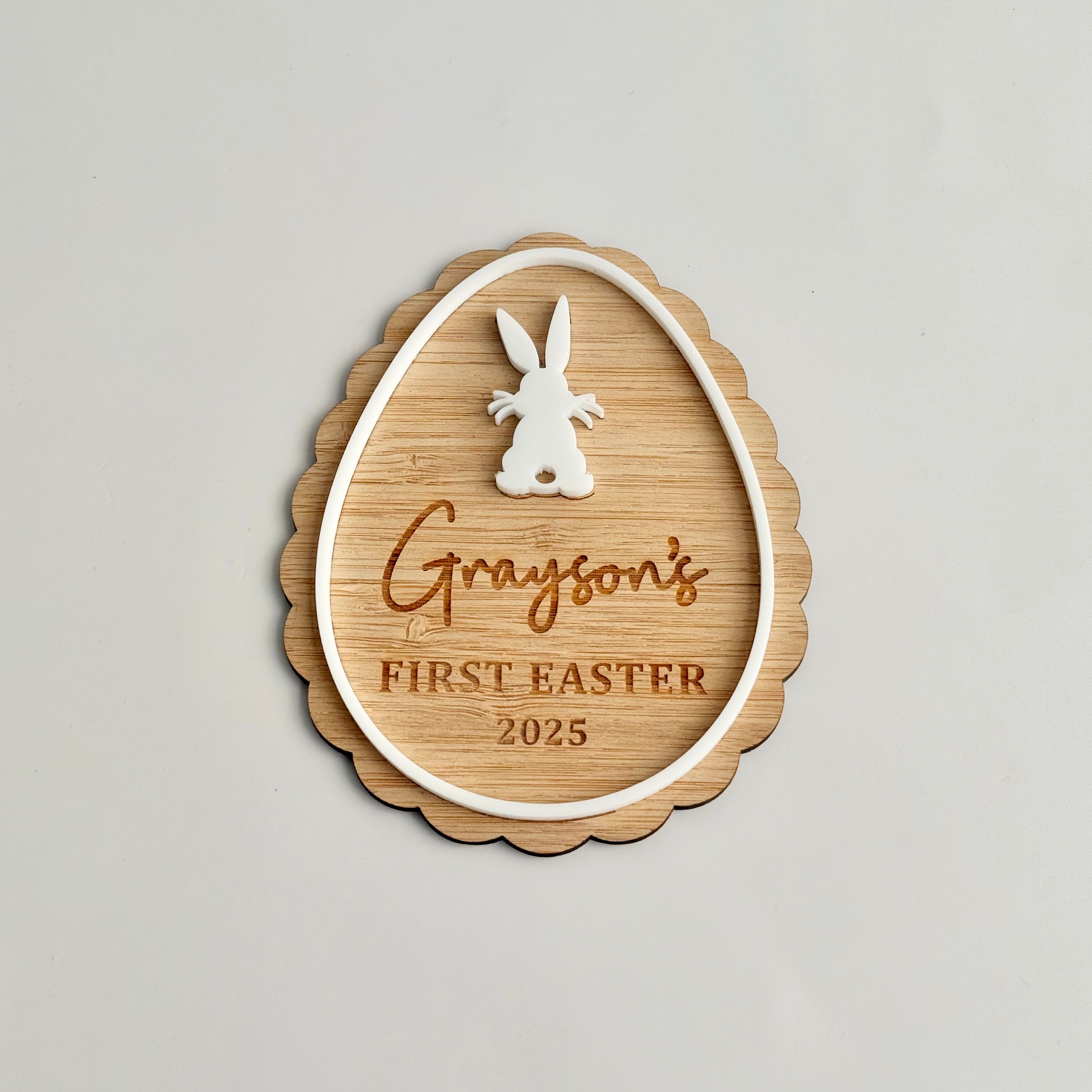 Personalised wooden Easter ornament with bunny detail engraved with “Grayson’s First Easter 2025” designed as a keepsake decoration
