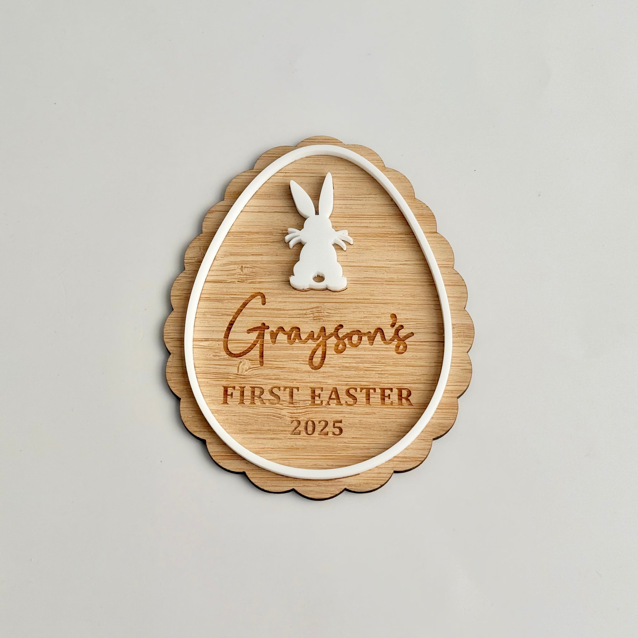 Personalised wooden Easter ornament with bunny detail engraved with “Grayson’s First Easter 2025” designed as a keepsake decoration