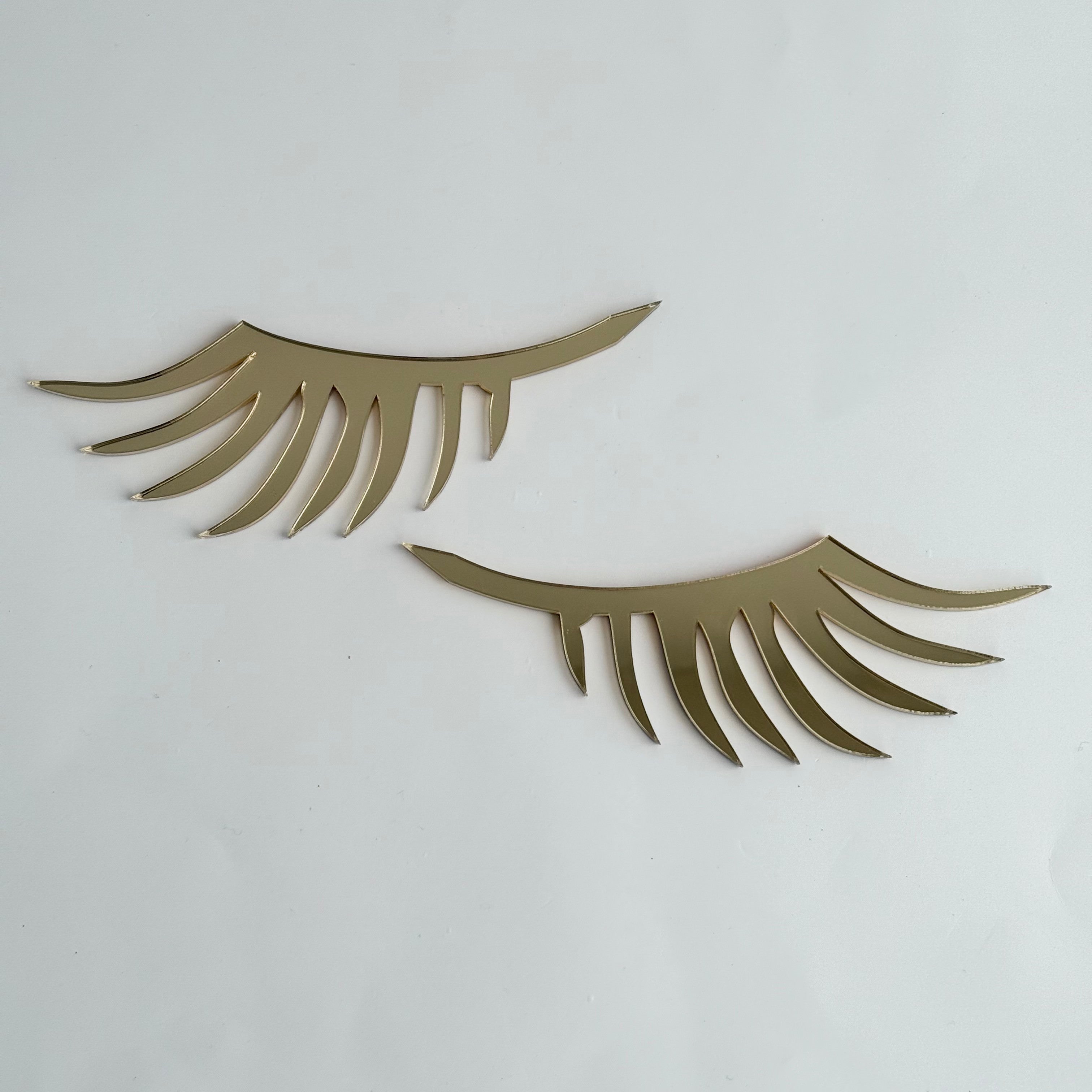 Gold acrylic eyelash wall decor set designed for nursery or kids room styling, adding a modern and minimal aesthetic