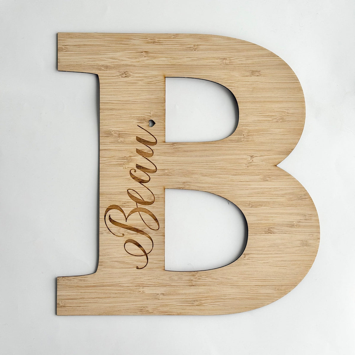 Personalised wooden letter B plaque engraved with the name Becai, made from natural bamboo for kids room or nursery decor