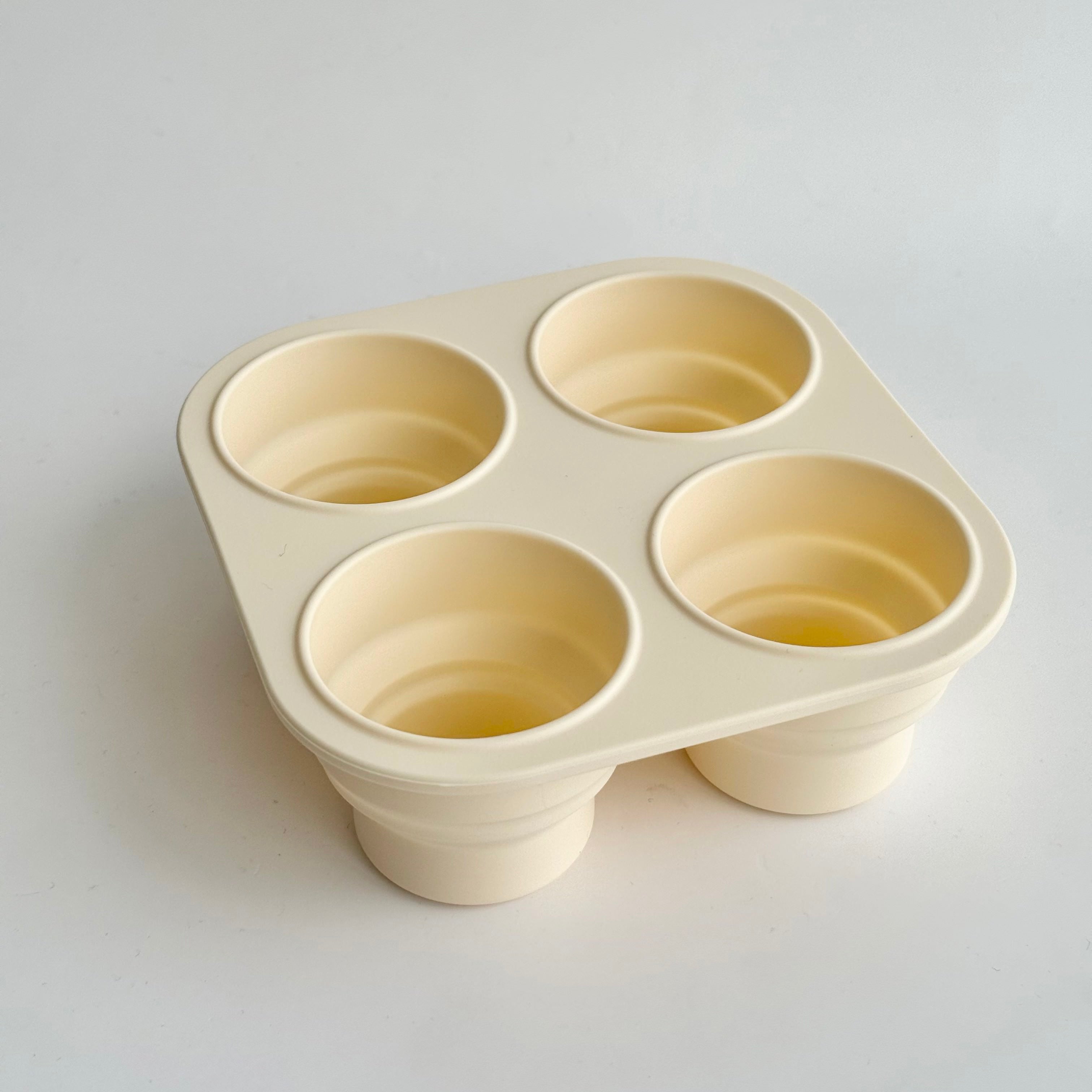 Cream silicone baby food freezer tray with multiple compartments for storing purees and snacks