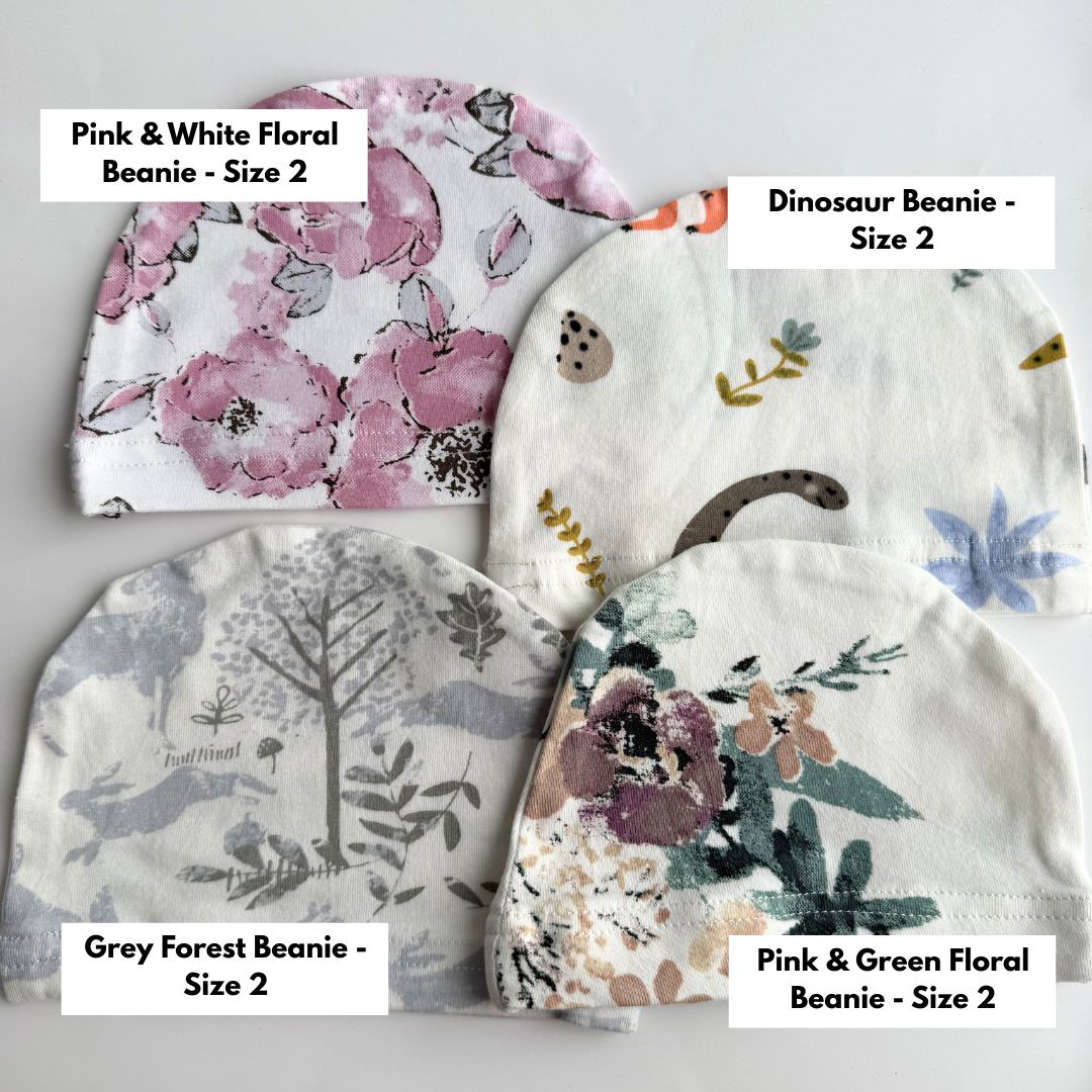 Clearance size 2 baby beanies including pink floral, dinosaur print, grey forest and pink green floral designs.