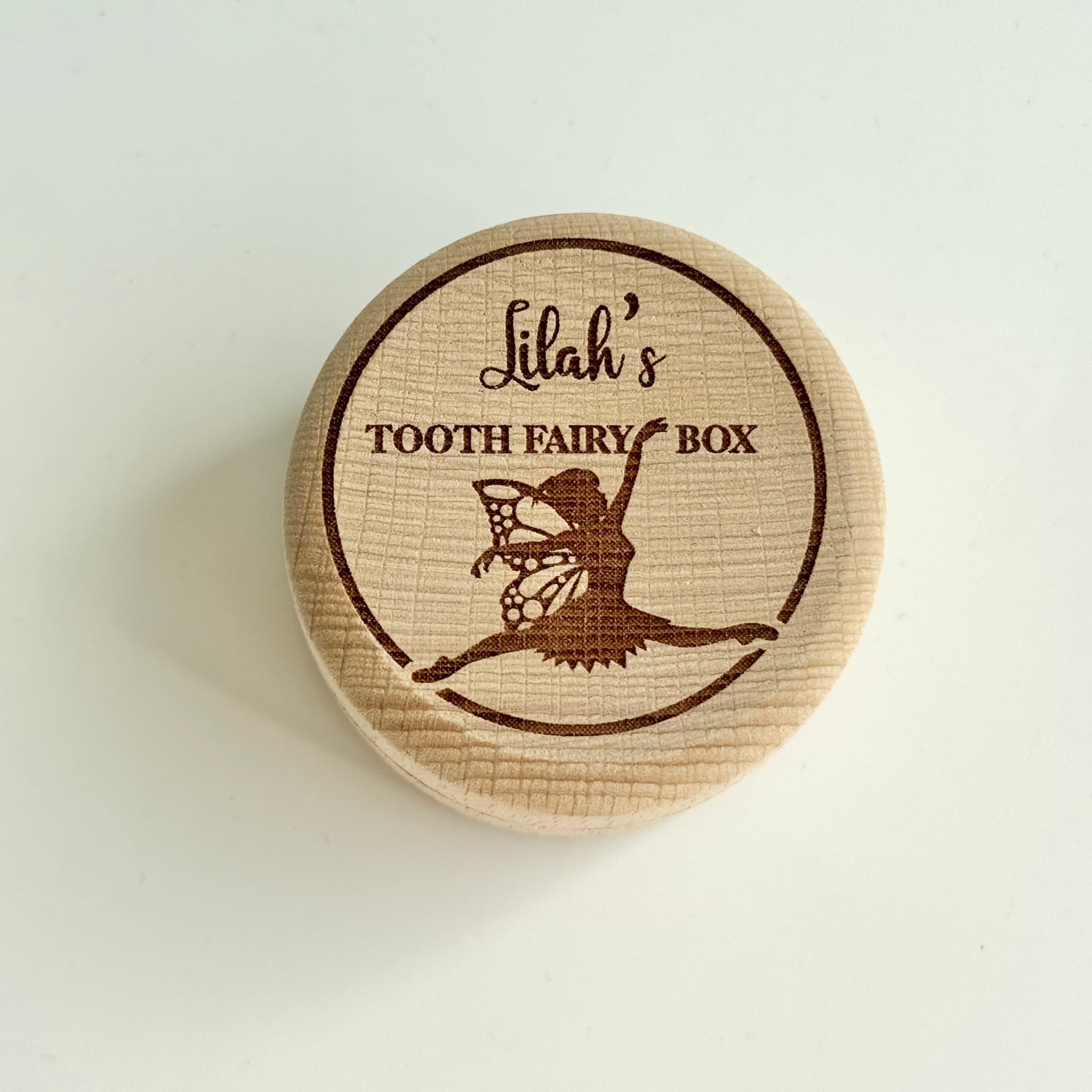 Personalised round wooden box engraved with fairy illustration and child’s name on lid