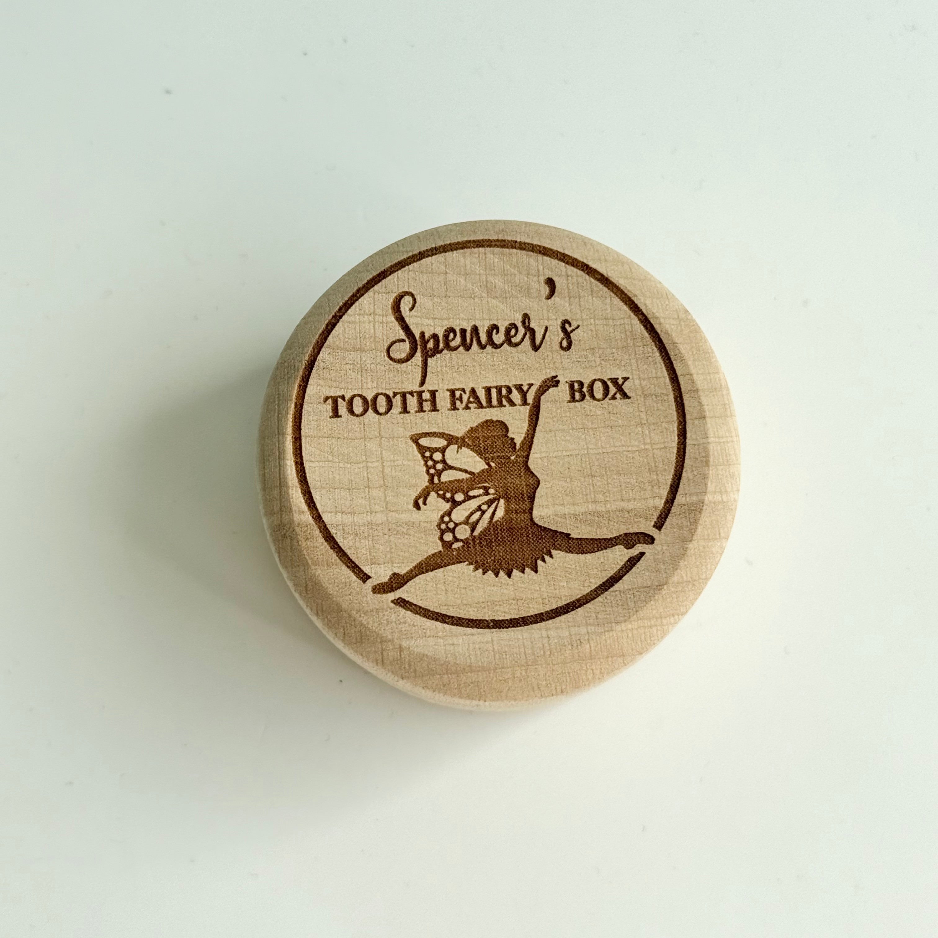 Round wooden personalised tooth fairy box engraved with fairy illustration and child’s name on lid