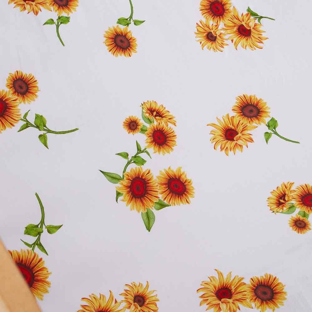 Close up of sunflower floral pattern on baby cot sheet for nursery bedding
