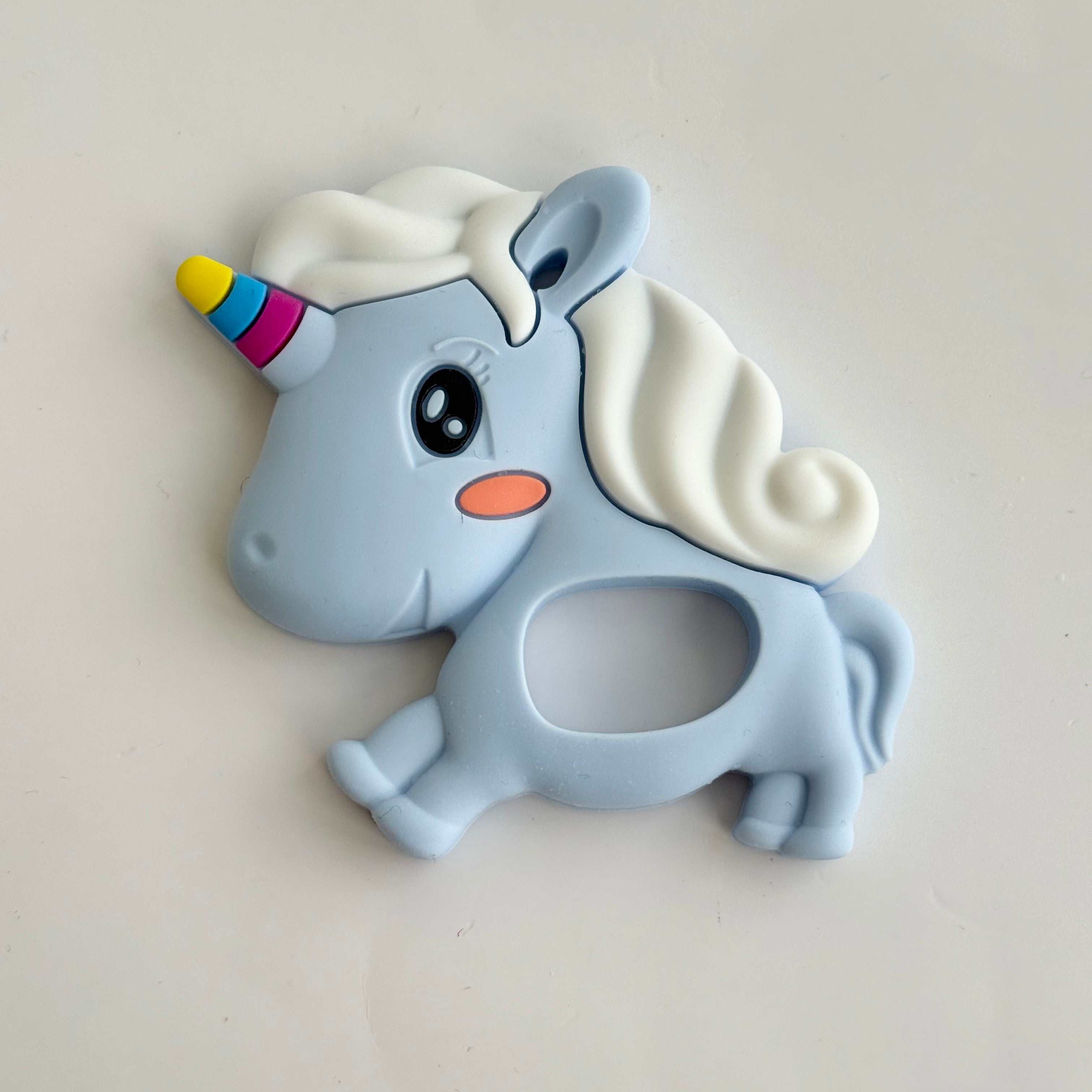 Blue silicone baby teether shaped like a unicorn for soothing teething gums