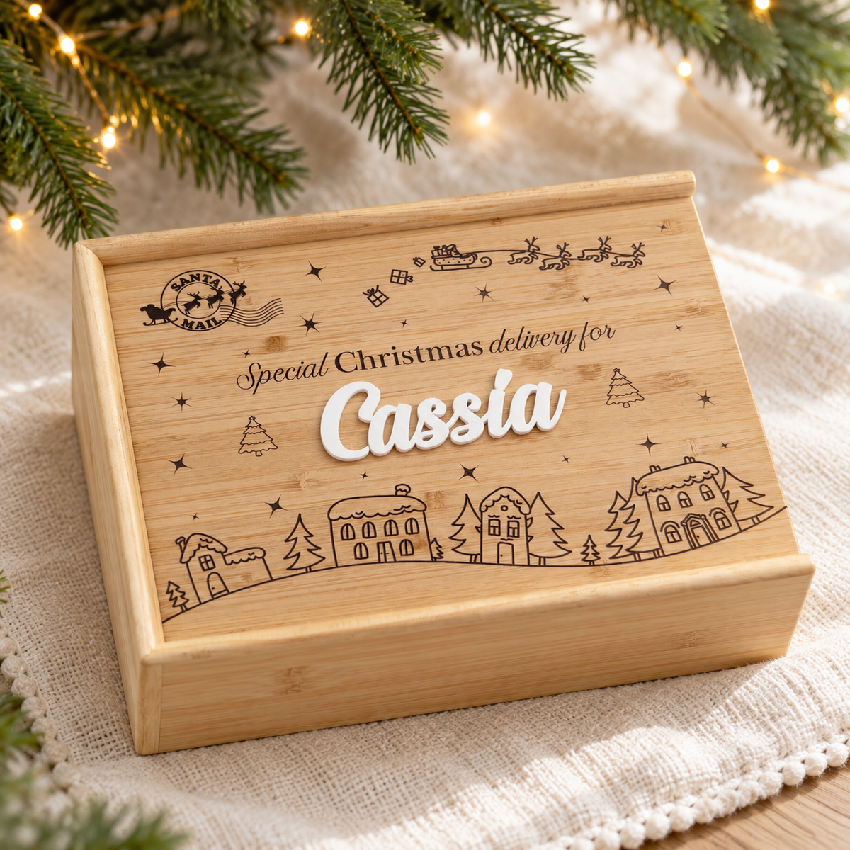 Personalised wooden Christmas Eve keepsake box with engraved bamboo sliding lid and white acrylic name lettering.
